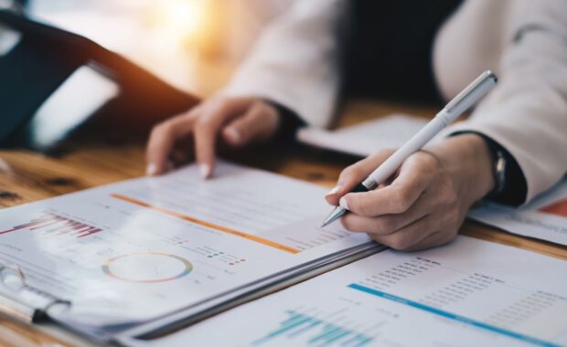 accountant woman working audit budget and finance of company on wooden desk in office