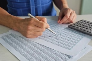 analyzing data with pen and calculator during work hours