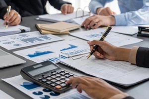 auditor and accountant team working in office, analyze financial data and accounting record with calculator