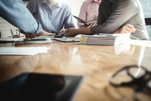 business colleagues are meeting to determine their duties to summarize annual performance in the company's meeting room
