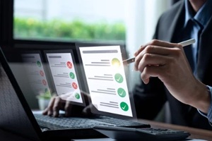 business performance checklist, businessman using laptop doing online checklist survey