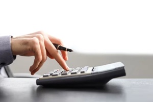 businessman is calculating with calculator