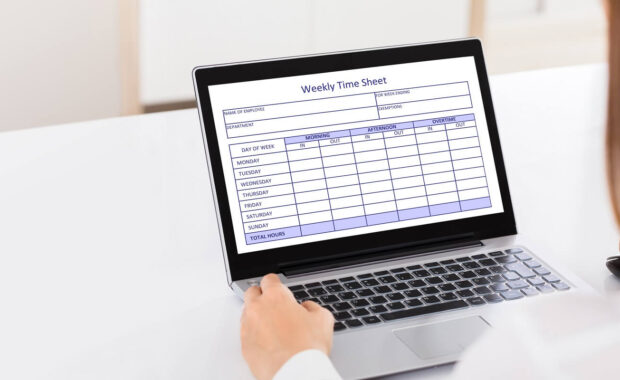 businesswoman filling weekly time sheet