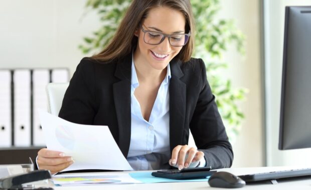 businesswoman using a calculator at office