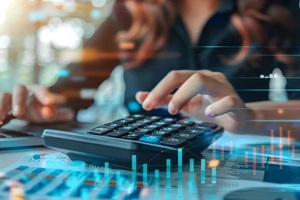 businesswoman using calculator to calculate financial report