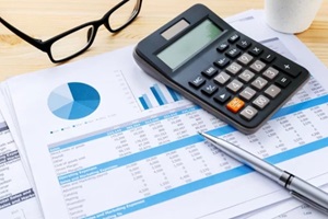 financial chart with calculator and pen