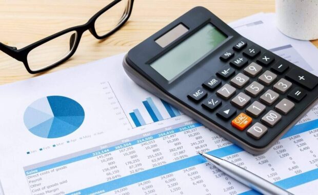 financial chart with calculator and pen