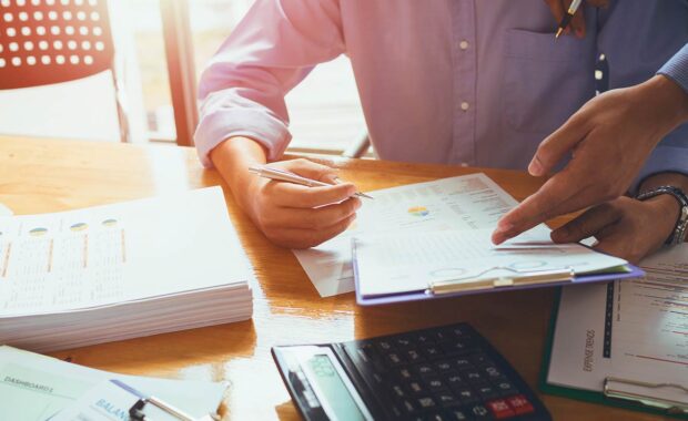 Government contractors filling out paperwork.