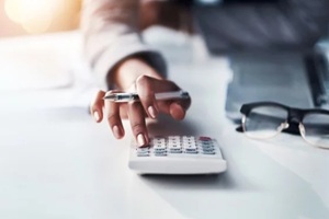 hand and calculator for finance, budget planning or accounting audit on mockup at office