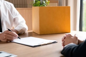 man signing resignation letter