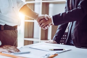 partner lawyers attorneys shaking hands after discussing a contract agreement done
