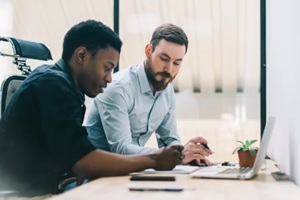 pensive adult multiethnic coworkers working on project in light modern office