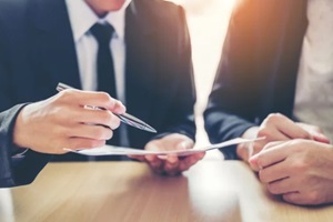 people discussing contracts terms and conditions