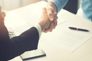 people shaking hands after contract done