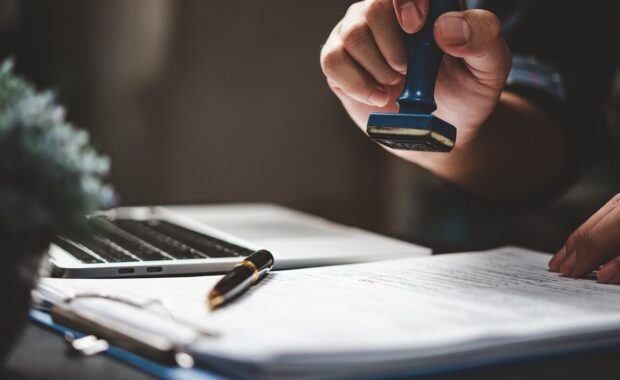 stamping approval of work finance banking or investment marketing documents on desk