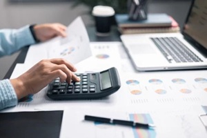 tax expense accounting budget money businessman hand use calculator