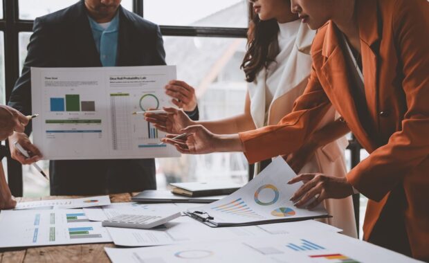 team of male and female businessmen work together to inspect sales documents