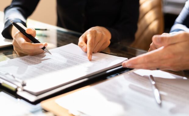 two business people working on contract paper