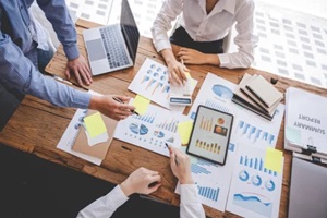 young colleagues discussing business and price chart analyzes business people on the table great in modern coworking office teamwork concept